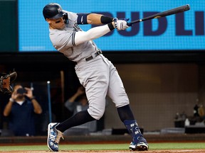 Aaron Judge of the New York Yankees hits his 62nd home run of the season during a game against the Texas Rangers at Globe Life Field on Oct. 4, 2022, in Arlington, Texas.