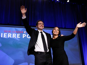 Pierre Poilievre, left, and his wife Anaida Poilievre take the stage after winning the Conservative party leadership election, in Ottawa on Sept. 10.