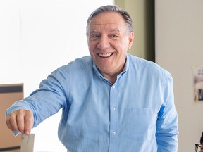 Coalition Avenir Quebec Leader Francois Legault casts his ballot at a campaign stop in L'Assomption, Que.