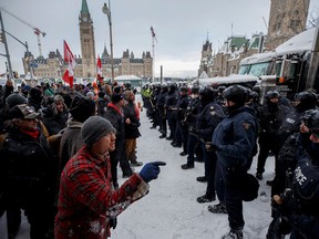 In this Feb. 19 photo, police move in to clear protesters from downtown Ottawa near Parliament Hill.