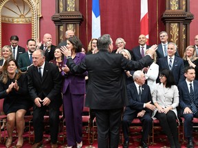 Quebec Premier Francois Legault, centre, thanks his new cabinet after they were sworn in, in the national assembly in Quebec City on Oct. 20.
