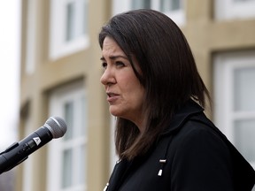 Alberta Premier Danielle Smith speaks to the media outside Government House following the swearing-in of her new cabinet ministers, in Edmonton, October 24, 2022.