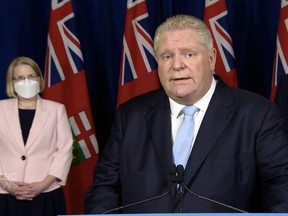 Ontario Premier Doug Ford, with then-Solicitor General Sylvia Jones, makes an announcement during ongoing convoy protests across Ontario, February 11, 2022.