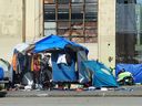 Tents are seen on the street in Vancouver's Downtown Eastside in a file photo from Aug. 24, 2022. Victims of street crimes perpetrated by encampment inhabitants are revictimized by pro-encampment activists, writes Adam Zivo.
