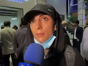 After landing in Tehran, Iranian climber Elnaz Rekabi said in an emotionless interview that going without a hijab had been an "unintentional" act on her part.