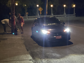 Civil servant Peter O’Neill sent this photo to Ottawa Police allegedly showing a group of Russian men jumping out of a car with diplomatic plates in order to vandalize some bikes owned by pro-Ukraine activists. For this, O’Neill got an “indefinite” ban from travel to the Russian Federation.