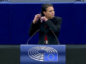 Swedish lawmaker Abir Al-Sahlani cuts her hair as she delivers a speech during EU debate on Iran protests at the European Parliament in Strasbourg, France October 4, 2022