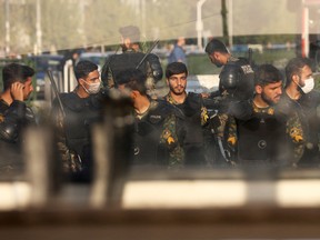 Iran's riot police forces stand in a street in Tehran, October 3, 2022. Protests against the country's cleric-led regime have now reached their third week.