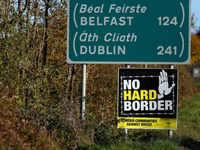 A 'No Hard Border' placard is seen beneath a road sign on the Irish side of the Ireland-Northern Ireland border near Bridgend, Ireland October 16, 2019.