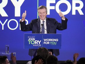 John Tory celebrates on stage after being elected for a third term as Toronto mayor, on Monday Oct. 24, 2022.