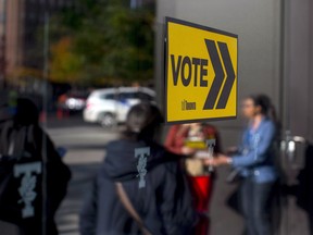 Voters line up outside a voting station to cast their ballot in the Toronto's municipal election, October 22, 2018.