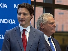 Prime Minister Justin Trudeau, left, accused Ontario Premier Doug Ford of hiding from his responsibilities during the Freedom Convoy protests.