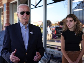 U.S. President Joe Biden, left, speaks to the media after casting his vote during early voting for the 2022 U.S. midterm elections with his granddaughter Natalie, in Wilmington, Del., on Oct. 29.
