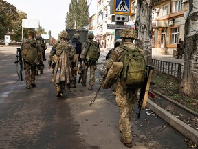 Ukrainian soldiers walk in Bakhmut, in Donetsk region, Ukraine, October 1, 2022.