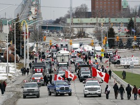 Protestors set up a blockade at the foot of the Ambassador Bridge in Windsor, Ont., sealing off the bridge into Canada from Detroit, on February 10, 2022. As a convoy of truckers and supporters occupied Ottawa's downtown, similar blockades and convoys popped up around the country.