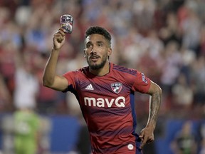 FC Dallas forward Jesus Ferreira (10) celebrates a goal against the Seattle Sounders while holding photos of his family on his shin guard in the second half of an MLS soccer match Saturday, May 7, 2022, in Frisco, Texas.