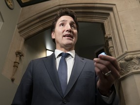 Prime Minister Justin Trudeau speaks with reporters before attending caucus on Parliament Hill, Wednesday, Oct. 19, 2022, in Ottawa.