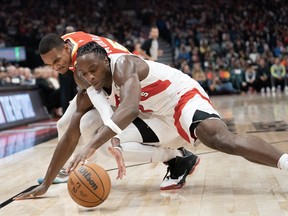 Toronto Raptors forward O.G. Anunoby (3) fights for the ball against Atlanta Hawks guard Dejounte Murray (5) during first half NBA basketball action in Toronto on Monday, October 31, 2022.