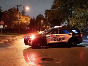 Police block the road at the scene of a shooting where a suspect shot at officers in Toronto, on Tuesday, Oct 18, 2022. The Toronto Police Service says they have made an arrest after a suspect inside a home shot at officers.