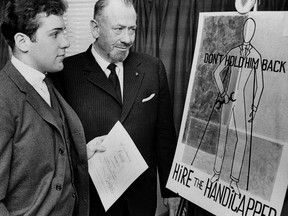 FILE -- Nobel prize-winning author John Steinbeck, right, admires a prize-winning poster by his son, Thomas Steinbeck, in Hartford, Conn., March 22, 1963. A tender and touching letter that author John Steinbeck penned to his teenage son, offering fatherly advice after the young man confided that he was in love for the first time, is going up for auction. "If you are in love -- that's a good thing -- that's about the best thing that can happen to anyone. Don't let anyone make it small or light to you," the Nobel literature laureate told his son, Thomas, in 1958. (AP Photo, File)