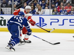 Detroit Red Wings centre Pius Suter (24) scores as Toronto Maple Leafs defenceman Mark Giordano (55) defends during first period NHL pre-season action, in Toronto, on Saturday, Oct. 8, 2022.