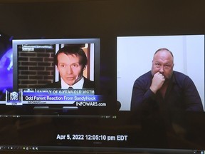A video of Alex Jones responding to questions about Infowars segments covering the Sandy Hook massacre is presented to the jury panel during Jones' defamation trial at Superior Court in Waterbury, Conn., on Thursday, Sept. 29, 2022.