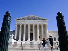 People take photos of U.S. Supreme Court on Tuesday, Oct. 11, 2022, in Washington.