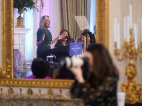 First lady Jill Biden is reflected in a mirror as she speaks during an event to launch the American Cancer Society's national roundtables on breast and cervical cancer in the State Dining Room of the White House, Monday, Oct. 24, 2022, in Washington.