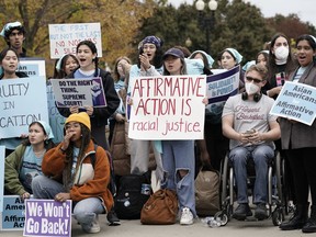 People rally outside the Supreme Court as the court begins to hear oral arguments in two cases that could decide the future of affirmative action in college admissions, Monday, Oct. 31, 2022, in Washington.