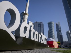 FILE - Branding is displayed near the Doha Exhibition and Convention Center in Doha, Qatar, Thursday, March 31, 2022. Qatar's ruling emir has lashed out at criticism of the country over its hosting of the 2022 FIFA World Cup, complaining of an "unprecedented campaign" targeting the first Arab nation to hold the tournament.