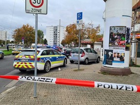 A street has been cordoned off in the Oggersheim district of the city of Ludwigshafen, Germany, Tuesday, Oct. 18, 2022. Two people were killed and another seriously hurt in a stabbing in southwestern Germany on Tuesday, police said. The suspected assailant was shot at during his arrest in the city of Ludwigshafen and seriously injured, German news agency dpa reported.