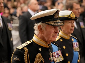 Britain's King Charles III, front, and Princess Anne follow the coffin of Queen Elizabeth II as it is pulled following her state funeral service in Westminster Abbey in central London, Monday, Sept. 19, 2022.&ampnbsp;
