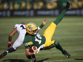 Montreal Alouettes Raheem Wilson (16) hits Edmonton Elks quarterback Taylor Cornelius (15) during first half CFL action in Edmonton, Alta., on Saturday October 1, 2022.&ampnbsp;Cornelius is set to miss the team's season finale due to a spleen injury, the team announced Monday. THE&ampnbsp;CANADIAN PRESS/Jason Franson.