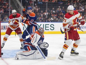 Calgary Flames' Walker Duehr (71) screens Edmonton Oilers' goalie Jack Campbell (36) as he makes the save during first period pre-season action in Edmonton on Friday, September 30, 2022.THE CANADIAN PRESS/Jason Franson