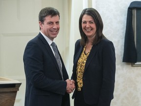 Todd Loewen shakes hands with Alberta Premier Danielle Smith after Loewen was sworn into cabinet as Minister of Forestry, Parks and Tourism in Edmonton, Monday, Oct. 24, 2022. An environmental group is warning a change to Alberta's United Conservative Party cabinet could threaten protections for the province's parks and wildlands.
