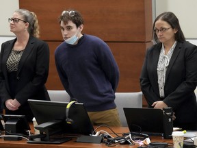 Marjory Stoneman Douglas High School shooter Nikolas Cruz, center, stands with members of his defense team as jurors enter the courtroom during the penalty phase of Cruz's trial at the Broward County Courthouse in Fort Lauderdale, Fla., on Thursday, Oct. 6, 2022. Cruz previously plead guilty to all 17 counts of premeditated murder and 17 counts of attempted murder in the 2018 shootings.
