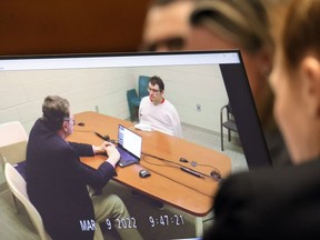 Marjory Stoneman Douglas High School shooter Nikolas Cruz is shown on a courtroom monitor during a videotaped interview with clinical neuropsychologist Dr. Robert L Denney as Dr. Denney testifies during the penalty phase of Cruz's trial at the Broward County Courthouse in Fort Lauderdale, Fla., on Thursday, Oct. 6, 2022. Cruz previously plead guilty to all 17 counts of premeditated murder and 17 counts of attempted murder in the 2018 shootings.