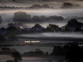 FILE - A regional train passes fog-covered fields in Wehrheim near Frankfurt, Germany, Oct. 7, 2022. Germany's federal and state transport officials said Thursday they want to introduce a public transit pass that costs 49 euros, 47 dollars, a month and be valid nationwide.