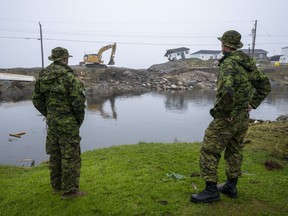 Canadian Armed Forces members from St John's survey the devastation left by post-tropical storm Fiona in Burnt Island, N.L., on Wednesday, September 28, 2022.THE CANADIAN PRESS/Frank Gunn
