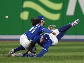 Toronto Blue Jays shortstop Bo Bichette (11) and Toronto Blue Jays centre-fielder George Springer (4) collide while to trying to catch a short fly ball during eighth inning American League wild card MLB baseball action against the Seattle Mariners in Toronto on Saturday, Oct. 8, 2022. A post-season appearance that ended shortly after it began has forced the Toronto Blue Jays to shift focus to the off-season earlier than they'd hoped. THE ;CANADIAN PRESS/Frank Gunn
