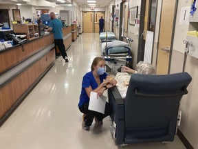 FILE - A nurse talks to a patient in the emergency room at Salem Hospital in Salem, Ore., on Aug. 20, 2021. Oregon voters are being asked in the November election to decide whether the state should be the first in the nation to amend its Constitution to explicitly declare that affordable health care is a fundamental human right.