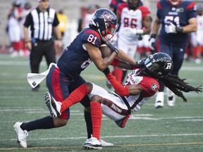 Montreal Alouettesâ€™ Tyson Philpot (81) is tackled by Ottawa Redblacksâ€™ Abdul Kanneh during first half CFL football in Montreal, Monday, October 10, 2022.
