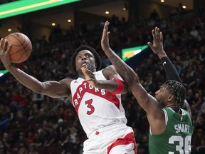 Toronto Raptors O.G. Anunoby (3) shoots around Boston Celtics Marcus Smart during second half NBA pre-season basketball action in Montreal, Friday, Oct. 14, 2022.