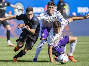 CF Montreal's Joaquin Torres, left, breaks away from Orlando City's Rodrigo Schlegel, right, during first half MLS soccer action in Montreal, Saturday, May 7, 2022. Currently riding a six-game unbeaten run and winners of eight of their last 10 matches, CF Montreal could not be in better form heading into its first Major League Soccer playoff game since 2016.