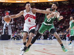 Toronto Raptors' Scottie Barnes (4) gets by Boston Celtics' Jayson Tatum during second half NBA pre-season basketball action in Montreal, Friday, Oct. 14, 2022.