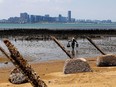 An oyster farmer walks in front of the nearby Chinese city of Xiamen on Lieyu Island, Kinmen County, Taiwan.