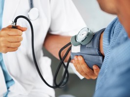 A doctor listening to his patient's heartbeat with a stethoscope