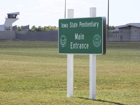 FILE - A sign stands outside the Iowa State Penitentiary in Fort Madison, Iowa, on July 1, 2017. A state board on Monday, Oct. 3, 2022, rejected claims for $1 million payments for 52 prison inmates at the penitentiary who were given six times the proper dose of COVID-19 vaccines last year.