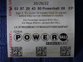 A Powerball ticket showing the estimated jackpot of $700 million is displayed, Tuesday, Oct. 25, 2022, in Urbandale, Iowa. The eighth-largest lottery jackpot will be up for grabs Wednesday night when numbers are drawn for an estimated $700 million Powerball grand prize.