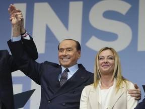 FILE - Forza Italia's Silvio Berlusconi, and Brothers of Italy's Giorgia Meloni attend the center-right coalition closing rally in Rome Thursday, Sept. 22, 2022. Italy's President Sergio Mattarella started formal consultations with political leaders Thursday, Oct. 20, 2022, with the aim of quickly giving the country a new government, which is expected to be the country's first led by the far right since the end of World War II.